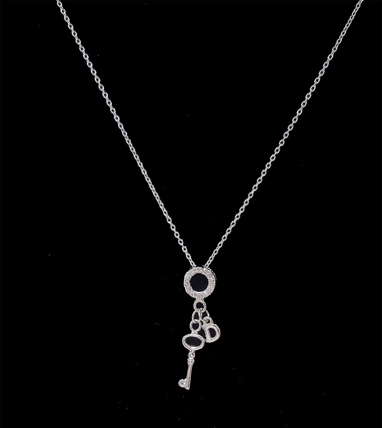 .925 Sterling Silver Key with Cubic Zirconia and Dangling Letter D Pendant SY83